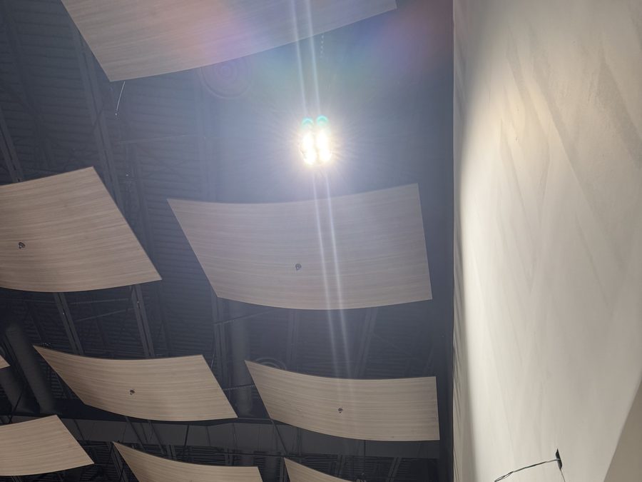 Curved acoustical panel installation from the side wall