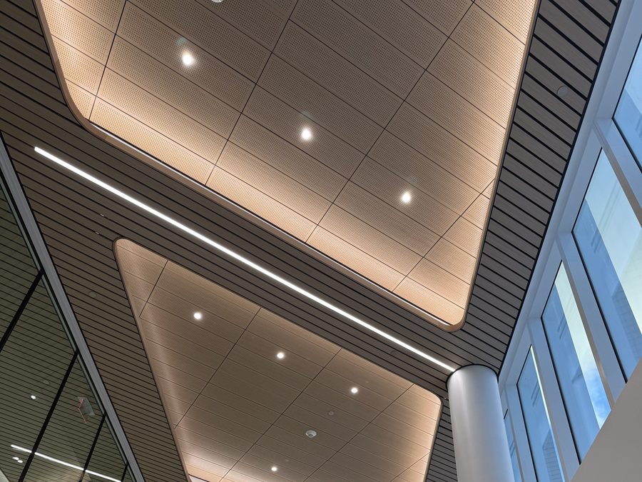 Illuminated ceiling panels above a two-story atrium