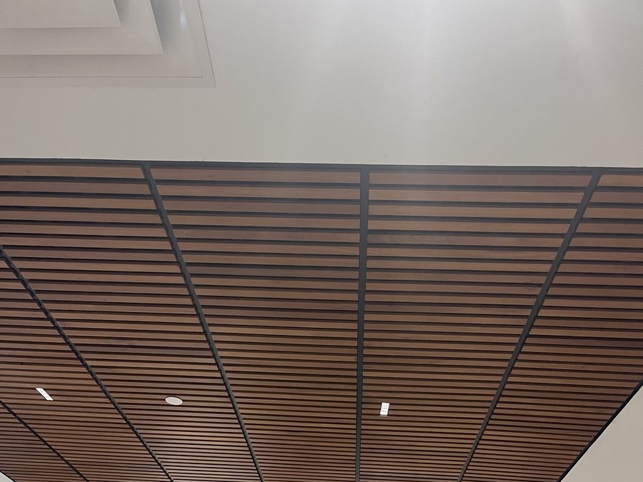 Linear wood ceiling within a recessed field