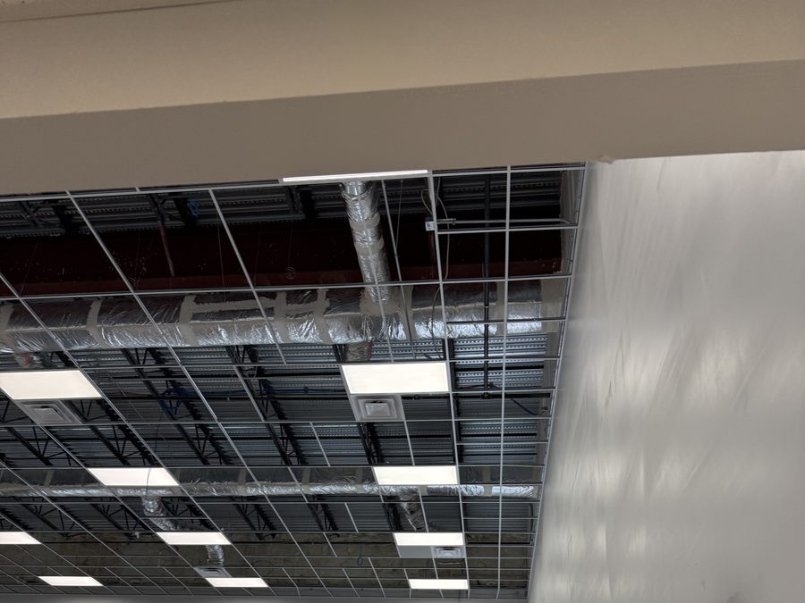 Ceiling grid installation along a finished wall